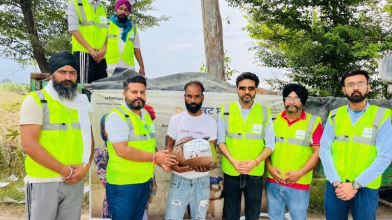 TREEI volunteers in safety vests with solar equipment
