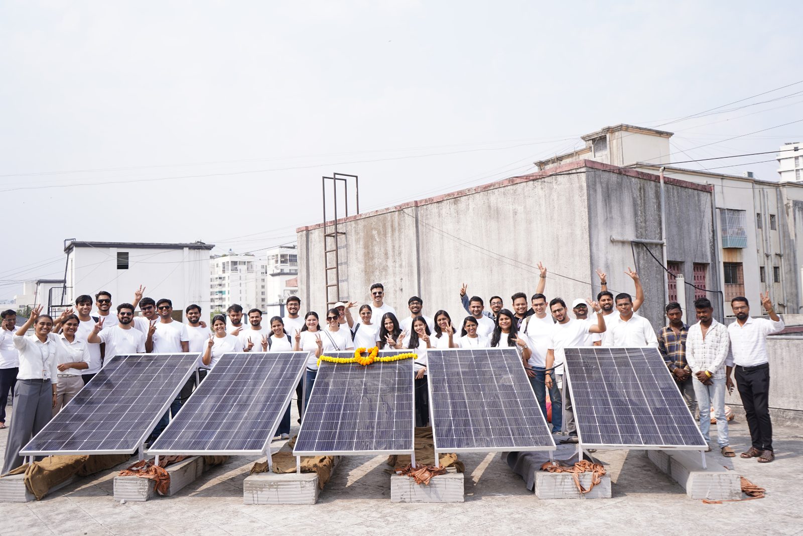 The Energy Exemplar volunteer team at the school's rooftop solar.