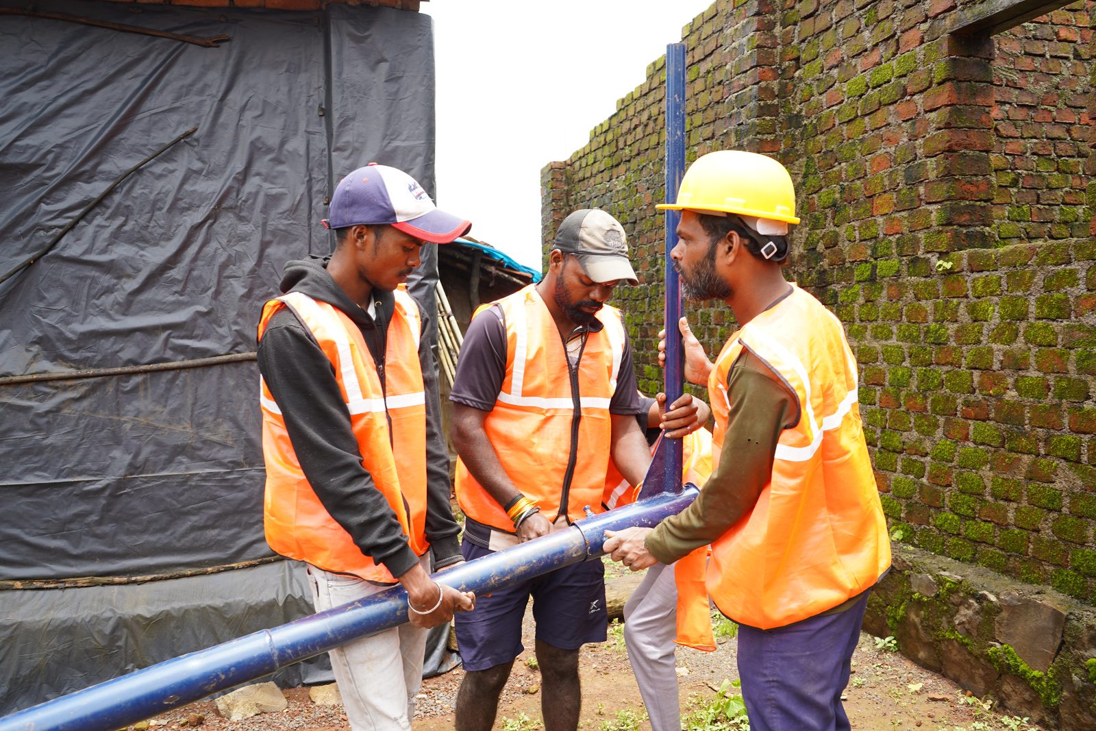 Local URJA technicians installing a solar pole in a Katkari tribal village, Maharashtra