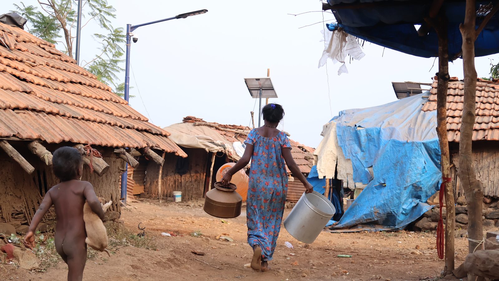 Integrated solar street lights in a Katkari hamlet. Each pole carries its own panel, battery and light.