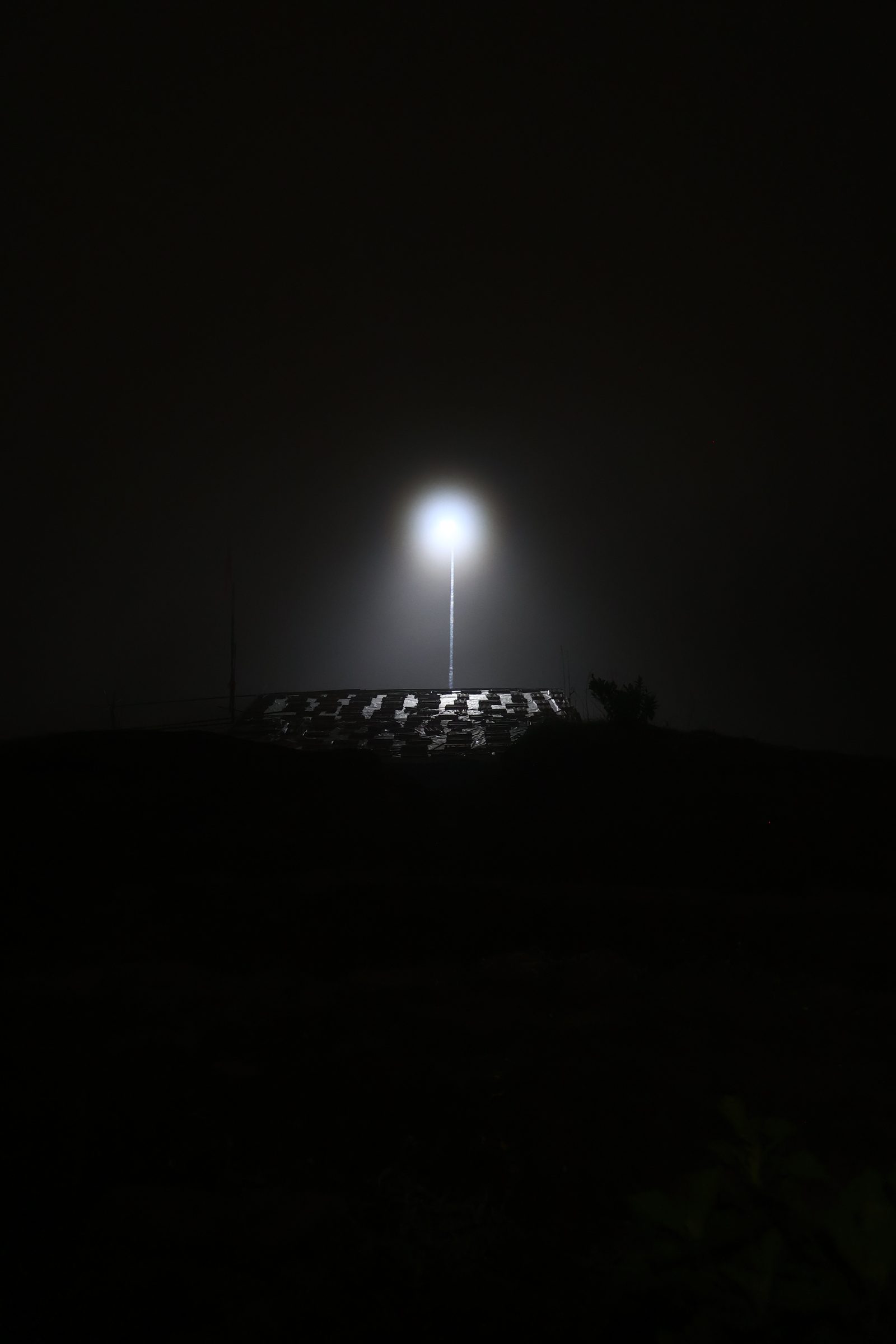 A solar street light holds through monsoon fog on the fort.